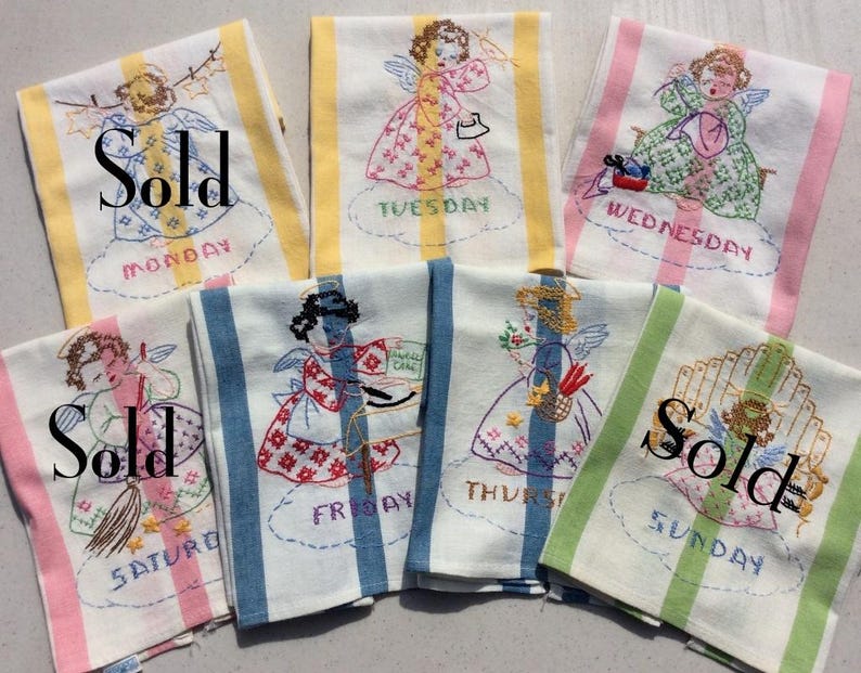 May include: A set of vintage embroidered kitchen towels, each marked with a day of the week. The towels have striped borders in different colours and feature angel designs. Some towels have the word "Sold" printed on them.