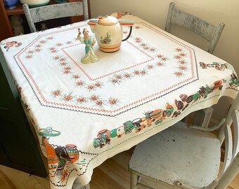 Mantel mexicano antiguo, vida en el pueblo y flores de cactus.