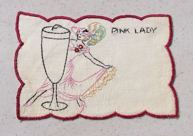 Vintage Cocktail Napkin Embroidered Showgirl Dips Beside a Pink Lady Risqu\u00e9 Glass Retro Bar