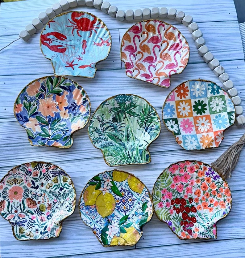 Deashell painted with gold rim and beachy designs to be used as a trinket dish