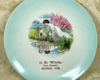 Vintage advertising plate reflection Cupid C R White grocer Neodesha Kansas