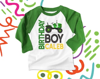 May include: White long-sleeve baseball tee shirt with green sleeves. The shirt has a green tractor graphic with the number 3 on it. The text "Birthday Boy Caleb" is printed on the shirt.