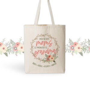 May include: A white canvas tote bag featuring a floral wreath design with the text "Only the best moms get promoted to grandma". The names "Addy, Natalie, Delaney, Harper" are listed below the wreath.