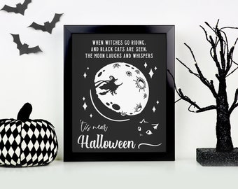May include: Black and white Halloween print with a witch flying on a crescent moon with the text "When witches go riding. And black cats are seen. The moon laughs and whispers 'tis near Halloween."