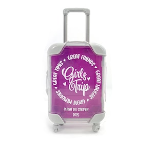 May include: A pink suitcase with a white circle design that says "Girls Trip" with hearts and the text "Great Times, Great Friends, Great Laughs, Great Memories". The suitcase also has the text "Playa del Carmen 2025" on the front.