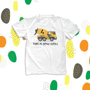 May include: White t-shirt with a yellow cement mixer truck graphic and the text "This is how I roll". The truck has the number "4" on the side.