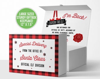 May include: A red and black plaid gift box with the text "Special Delivery from the office of: Santa Claus Official Elf Division". The box is 12 inches by 7.5 inches. The lid of the box is open, revealing a white card with the text "Crayon the Elf I'm Back! Has returned for official elf duty, assigned by his royal Clausness, Santa, Kid:"