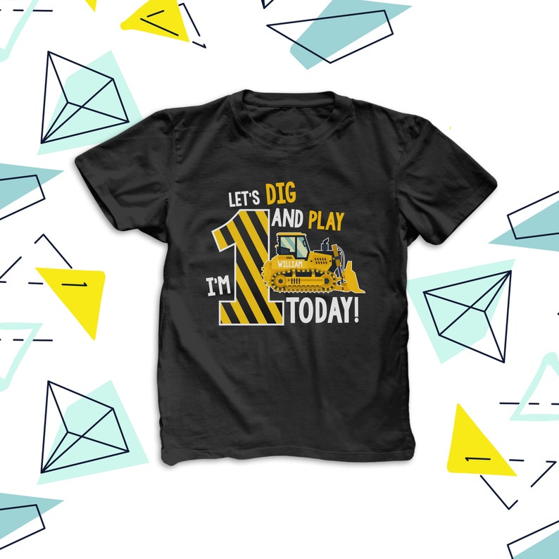 May include: Black t-shirt featuring a yellow and black striped number 1 and a bulldozer graphic. The text on the shirt reads "Let's Dig and Play, I'm 1 Today!" and includes a name. This is a birthday-themed garment.