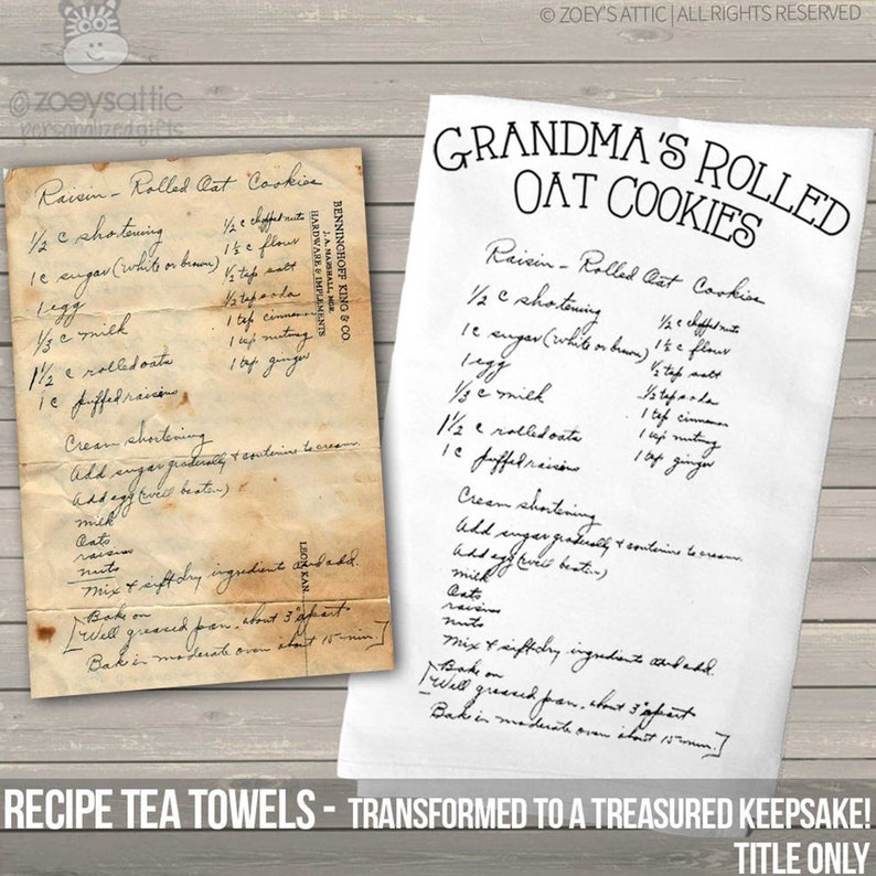 May include: A white tea towel featuring a printed recipe for Grandma's Rolled Oat Cookies, displayed next to an aged, stained paper original of the same handwritten recipe. The text includes ingredients like shortening, sugar, egg, milk, oats, and raisins.