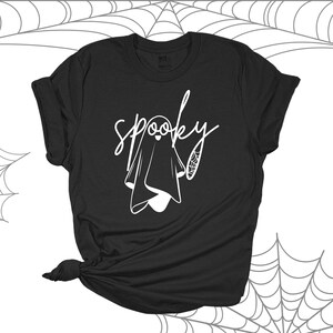 May include: Black t-shirt with a white ghost and the word "spooky" written in a cursive font.