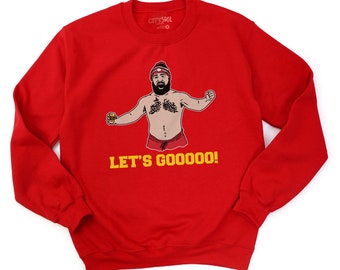 May include: Red sweatshirt with a cartoon illustration of a man wearing a Santa hat and holding a beer. The text "LET'S GOOOO!" is printed in yellow below the illustration.
