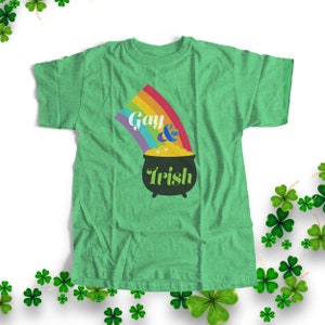 May include: Green t-shirt with a rainbow and pot of gold graphic. The text on the shirt reads "Gay & Irish".