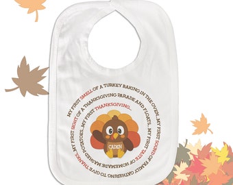 May include: White baby bib with a Thanksgiving turkey design and the text "MY FIRST SMELL OF A TURKEY BAKING IN THE OVEN...MY FIRST SIGHT OF A THANKSGIVING PARADE AND FLOATS...MY FIRST SOUND OF FAMILY GATHERING TO GIVE THANKS...MY FIRST TASTE OF HOMEMADE MASHED POTATOES...MY FIRST THANKSGIVING..." with the name "CADEN" on the turkey.