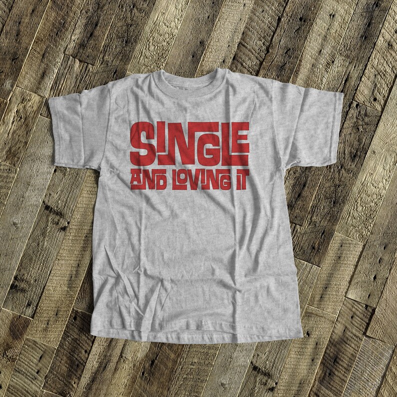 May include: Gray t-shirt with the text "SINGLE AND LOVING IT" in red.
