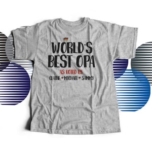 May include: Gray t-shirt with the text "World's Best Opa" and a small German flag graphic. Below the text is "As voted by:" and the names "Claire, Michael, Sammy".