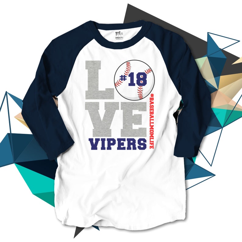 May include: White baseball t-shirt with a navy blue raglan sleeve. The shirt has a gray graphic that says "LOVE" with a baseball graphic that says "#18" and "VIPERS" below. The text "#BASEBALLMOMLIFE" is on the side of the baseball graphic.
