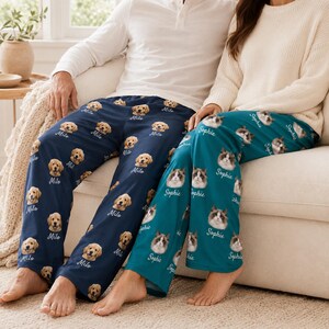 May include: Two pairs of lounge trousers featuring custom photo prints. The dark blue trousers display a golden retriever face pattern with the name Milo printed below each. The teal trousers feature a cat face pattern with the name Sophie printed below each.