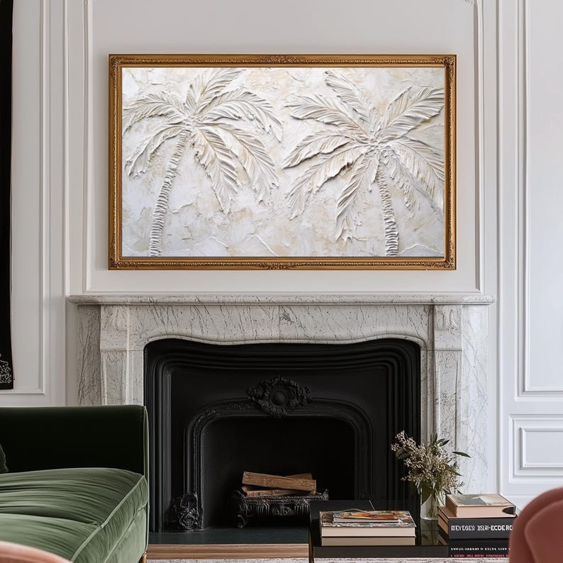 May include: A framed wall art print featuring a white textured relief of two palm trees against a white background. The frame is gold.