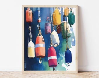 May include: Watercolour painting of colourful buoys hanging against a blue and green background. The buoys are various shapes and colours, including red, yellow, and blue. The artwork is framed in a light wood frame.