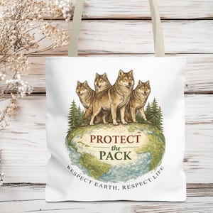 May include: White tote bag featuring a watercolor illustration of five wolves standing on a globe. The text "PROTECT THE PACK" is centered, with "RESPECT EARTH, RESPECT LIFE" below. The bag has beige straps.