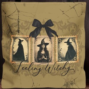 May include: Tan tote bag with black handles and a Halloween theme. The bag features three framed witch illustrations and the text "Feeling Witchy." A carved orange pumpkin sits nearby.