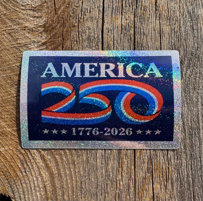 May include: A rectangular sticker with a navy blue background and a silver glitter border. The word "AMERICA" is at the top, with a red, white, and blue "250" design below. The text "1776-2026" is at the bottom, with stars on each side.