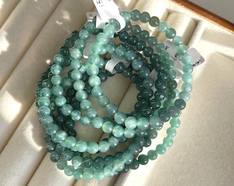 Pulseira de jadeíta guatemalteca natural azul-esverdeada com contas de 5,6 a 6 mm.