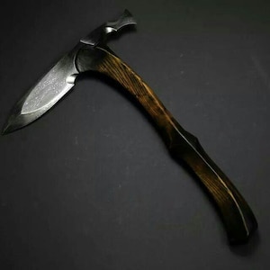 Könnte beinhalten: Eine handgefertigte Axt mit einem dunklen Holzgriff und einer Stahlklinge. Die Klinge hat eine spitze Kante und einen Hammer auf der gegenüberliegenden Seite. Der Griff ist etwa 35,5 cm lang.