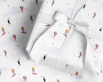 May include: White wrapping paper with a repeating pattern of skiers and snowboarders in various outfits. The wrapped gift is tied with a white satin ribbon and bow. The background features soft, gray mountain shapes.