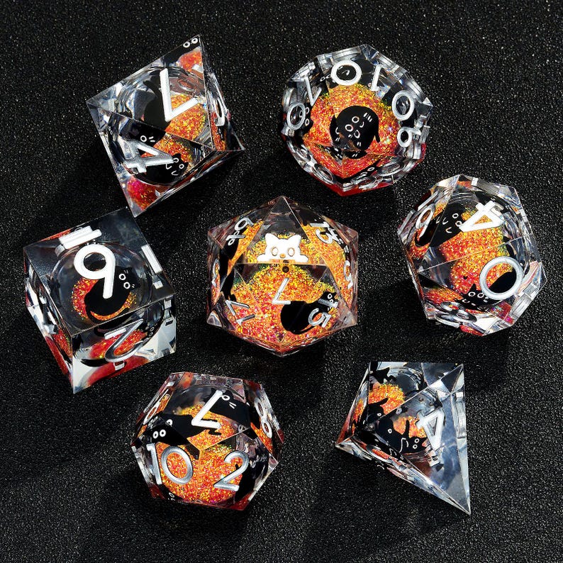May include: Set of seven clear dice with black and orange glitter. The dice are numbered 1-6 and have a black cat design on each face.