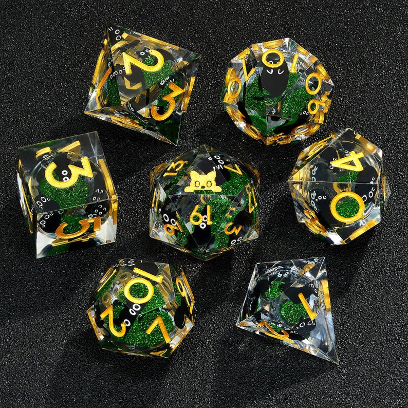 May include: Set of seven green and gold dice with black numbers and a black cat graphic on one die. The dice are made of clear acrylic with glitter embedded in the plastic.
