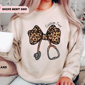 Personalized Coquette Nurse Sweatshirt, Leopard Print Stethoscope Bow, Sweatshirt Gift for Nurse, Nurse Graduation, Healthcare