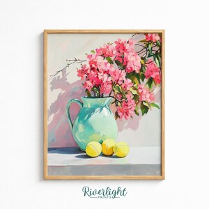May include: A framed art print featuring a light turquoise ceramic pitcher filled with vibrant pink bougainvillea flowers, positioned next to three yellow tennis balls on a flat surface, with the text Riverlight Prints at the bottom.