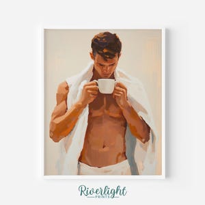 Op de afbeelding: Een ingelijste print van een man die een witte mok vasthoudt, gehuld in een witte handdoek. Het kunstwerk maakt gebruik van warme tinten en een zachte, schilderachtige stijl. De print is geplaatst tegen een neutrale achtergrond. De tekst "Riverlight Prints" staat onderaan.