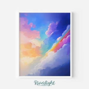 Può includere: Una stampa artistica incorniciata con una scena di cielo colorato con un arcobaleno. L'opera d'arte raffigura un arcobaleno che si inarca attraverso nuvole soffici in tonalità di rosa, giallo, blu e viola. La stampa è su sfondo bianco, con il testo "Riverlight Prints".