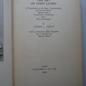 May include: A book titled "The Art of Good Living: A Contribution to the better Understanding of Food and Drink, together with a Gastronomic Vocabulary and a Wine Dictionary" by André L. Simon, with a frontispiece after Daumier and a foreword by Maurice Healy. Published in London by Constable & Co Ltd in 1929.