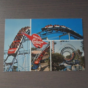 May include: A vintage postcard featuring a photo of Knott's Corkscrew roller coaster. The postcard shows multiple angles of the ride, including the entrance sign, the corkscrew loop, and riders going up a hill.
