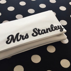 Ivory satin MRS bridal clutch for wedding day.  It can be personalised with the brides new surname, made from black glitter.