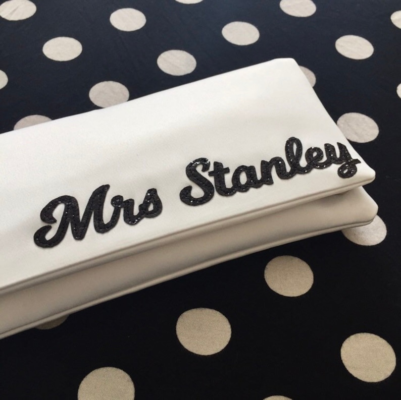 Ivory satin MRS bridal clutch for wedding day.  It can be personalised with the brides new surname, made from black glitter.