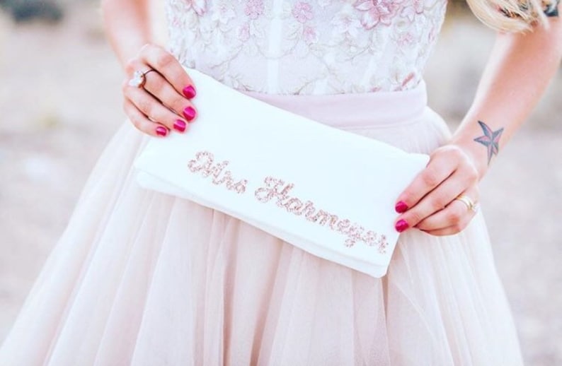Ivory satin MRS bridal clutch for wedding day.  It can be personalised with the brides new surname, made from rose gold glitter.