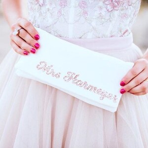 Ivory satin MRS bridal clutch for wedding day.  It can be personalised with the brides new surname, made from rose gold glitter.