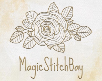 May include: A line drawing of a rose with leaves in gold on a beige background. The text "Magic Stitch Bay" is written below the rose.