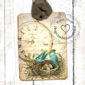 May include: A vintage-style card with a clock face, two blue birds in a nest with eggs, and a stamp that reads "Print Shop HugsAndStitchesPrints".