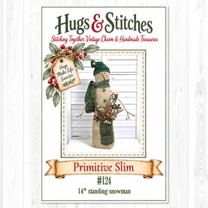 May include: A fabric snowman figure with a green hat and scarf, holding a small bouquet of twigs and a candy cane. The text reads Hugs & Stitches, Stitching Together Vintage Charm & Handmade Treasures, Hugs Make Life Sweeter, Primitive Slim #124, 14" standing snowman.