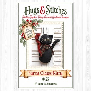 May include: A black fabric cat ornament wearing a red Santa hat and a plaid scarf with a small bell. The text reads Hugs & Stitches, Stitching Together Vintage Charm & Handmade Treasures, Hugs Make Life Sweeter, Santa Claws Kitty #125, 6" santa cat ornament.