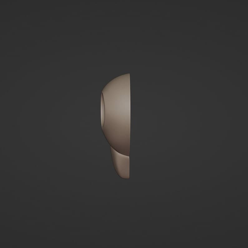 May include: A side view of a light brown, rounded object with a circular opening. The object has a smooth surface and a curved shape, possibly a part of a larger design or product. The background is a solid, dark gray color.