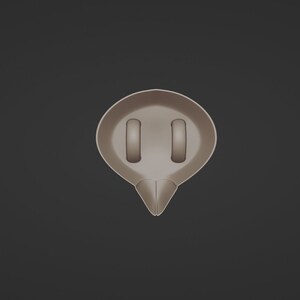 May include: A light brown, abstract-shaped object with two rectangular cutouts and a pointed bottom. The object is centered against a dark gray background, with a smooth, matte finish.