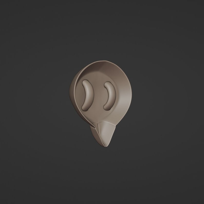 May include: A brown, teardrop-shaped object with two curved, oblong cutouts near the top. The bottom of the object tapers to a point. The object is set against a dark gray background.