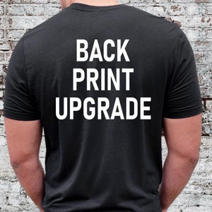 May include: Black t-shirt with white text that reads "BACK PRINT UPGRADE" on the back.
