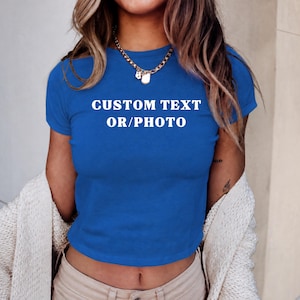 A woman wearing a blue cropped top with the text "CUSTOM TEXT OR/PHOTO" printed on it.